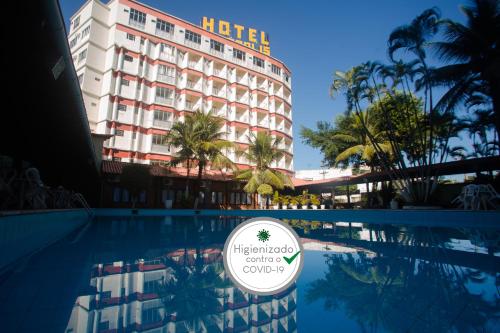 a hotel with a swimming pool in front of a hotel at Acrópolis Marina Hotel in Angra dos Reis