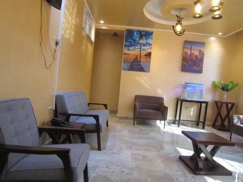 a waiting room with chairs and tables in a hospital at Jakicha Motel in Dar es Salaam