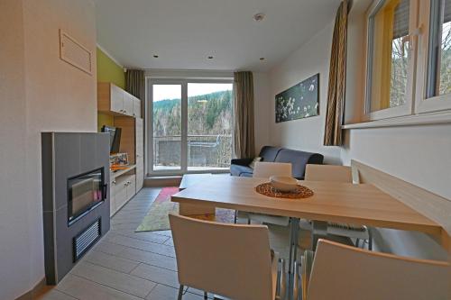 a kitchen and living room with a table and a living room at Hotel Jirinka in Dolní Morava