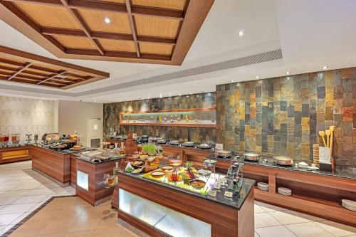 a large kitchen with a buffet in a restaurant at Club Mahindra Emerald Palms, Goa in Varca