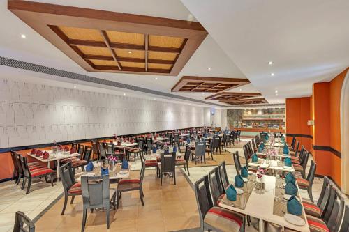 a dining room filled with tables and chairs at Club Mahindra Emerald Palms, Goa in Varca