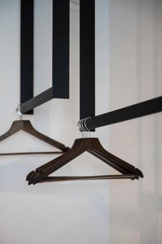 a pair of wooden hangers in a room at Hotel Pax in Diksmuide