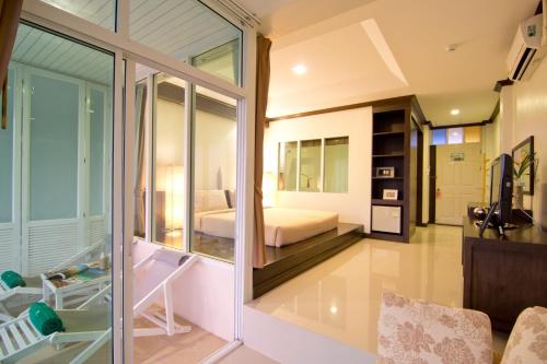 a room with a bedroom with a bed and a window at Makathanee Resort in Ko Mak