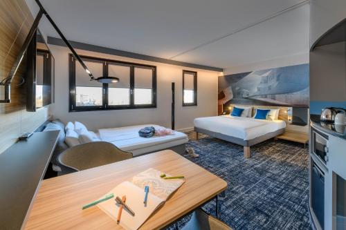 a living room with a couch and a table at Novotel Suites Berlin City Potsdamer Platz in Berlin