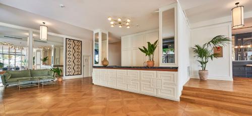 an empty lobby with a bar with plants in it at Hoposa Daina- Adults Only in Port de Pollensa