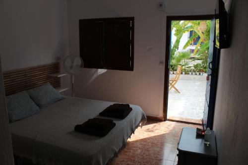 a bedroom with a bed and a door to a patio at Casaflor in Mojácar