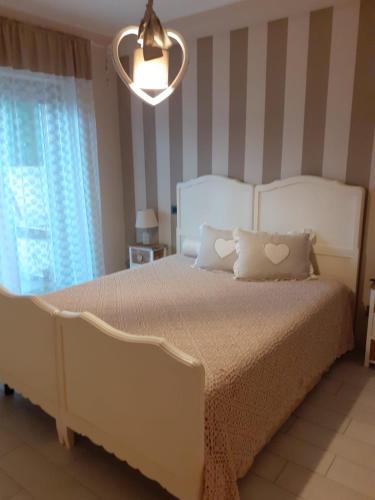 a bedroom with a bed with two pillows on it at Casa Spina in San Giovanni Teatino