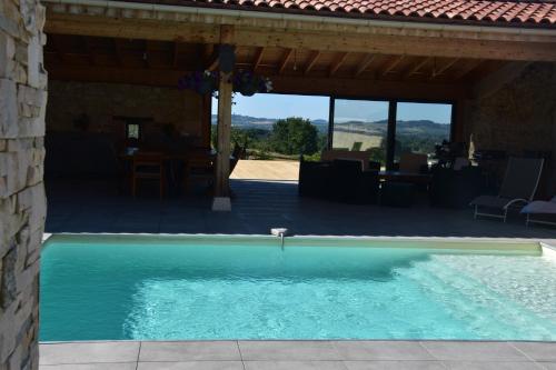 a swimming pool in front of a house at Domaine de calbiac in Dolmayrac