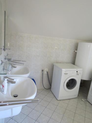 a bathroom with a washing machine and a sink at Holiday Villa Lake Lipno in Lipno nad Vltavou