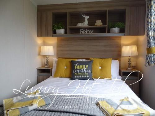 a bedroom with a bed with a wooden headboard at Luxury Hot Tub Retreat in Tattershall
