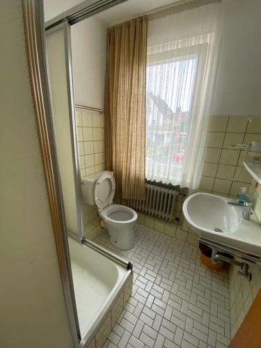 a bathroom with a tub and a toilet and a sink at Hotel Seehaus in Horn-Bad Meinberg