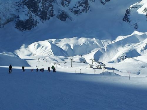 a group of people skiing on a snow covered mountain at Alpina Residence in Solda