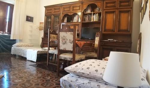 a living room with a wooden cabinet and a tv at Vasari Home in Arezzo