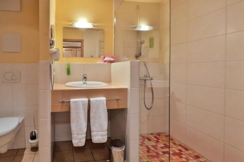 a bathroom with a sink and a shower at Landgasthof Deutsches Haus KG in Weilheim an der Teck