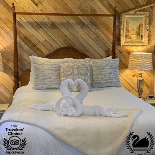 two swan towels on a bed in a room at Peace & Plenty Inn Bed and Breakfast Downtown St Augustine-Adults Only in Saint Augustine