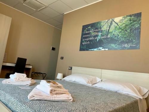 a bedroom with two beds with towels on them at LA BUSSOLA in Badia Polesine