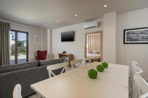 a living room with a couch and a table at Spilia Village Hotel & Villas in Spiliá