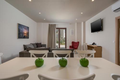 a living room with a table with two green apples on it at Spilia Village Hotel & Villas in Spiliá