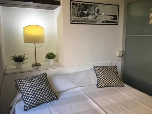 a white couch with two pillows in a room at Cosy Trastevere in Rome