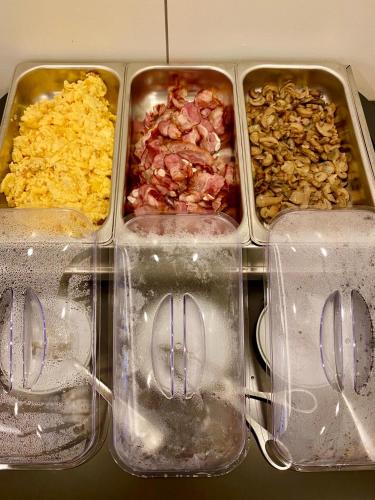 four plastic containers filled with different types of food at Apulia Praia Hotel in Esposende