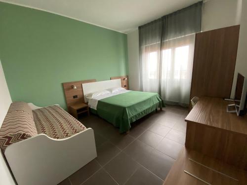 a room with two beds and a window in a room at Pansini Hotel Residence in Badolato