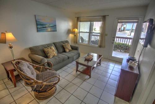 a living room with a couch and a table at SURFSIDE II 107 condo in South Padre Island