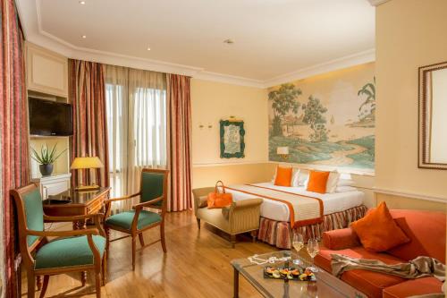 a hotel room with a bed and a living room at Donna Laura Palace by OMNIA hotels in Rome
