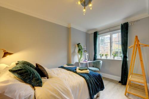 a bedroom with a bed and a window and a ladder at Portland Street Leamington Spa Apartments in Leamington Spa