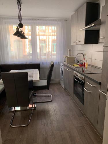a kitchen with a table and chairs in a room at Schönes Zuhause in Hildesheim