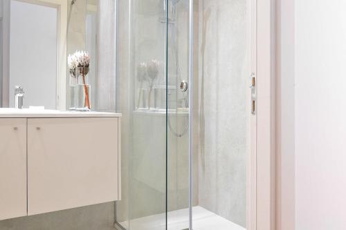 a shower with a glass door in a bathroom at Casa Balthazar in Lisbon