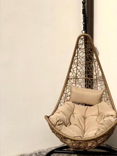 a hanging basket chair with a pillow in a room at Relais Villa Montedonzelli in Naples
