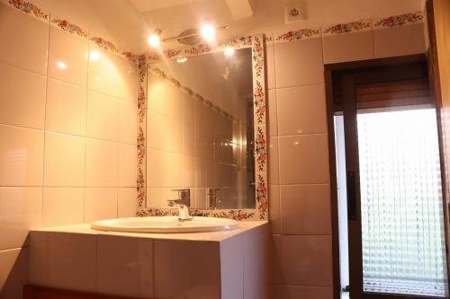 a bathroom with a sink and a mirror at La Caseta Benimantell in Benimantell