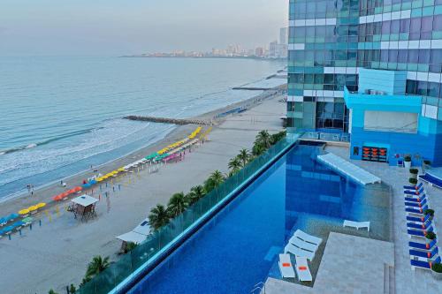 een zwembad naast een strand en een gebouw bij Hotel InterContinental Cartagena, an IHG Hotel in Cartagena
