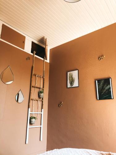 a bedroom with a ladder and some pictures on the wall at chambre salle de bain partagée in Cognac