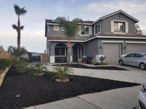 a house with a car parked in a driveway at Beautiful City Lights and Mountain Views in Menifee