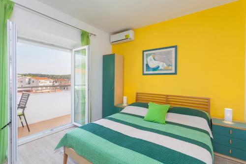 a bedroom with a bed and a balcony at Apartments & Rooms Alagić in Makarska