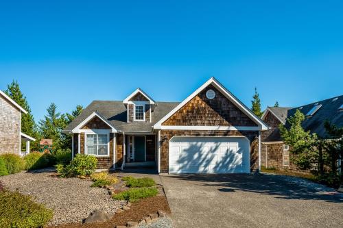 a house with a garage and a driveway at Sunrise Serenity in Manzanita