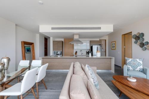 a living room with a couch and a table at Exclusive apartment- Rooftop pool in Cancún