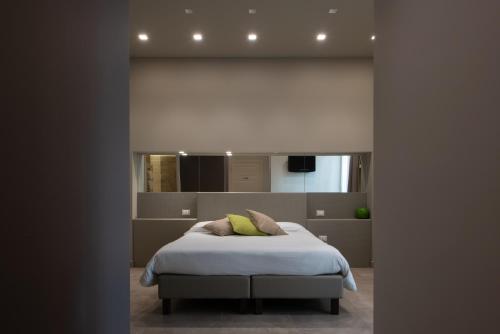 a bedroom with a bed and a large mirror at B&B Palazzo Paciotti in Trani