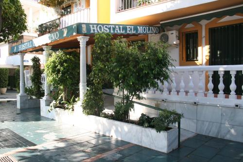 a building with a street sign on the side of it at HOSTAL EL MOLINO in Marbella