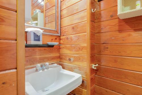 a bathroom with a white sink and wooden walls at Key West Villas in Key West