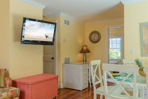 a living room with a flat screen tv on the wall at Key West Villas in Key West