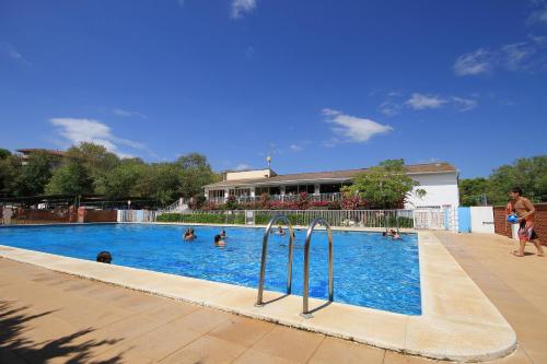 a group of people swimming in a swimming pool at Camping La Rueda in Cubelles