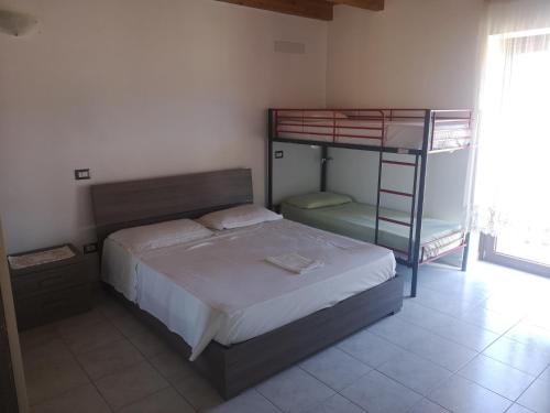 a bedroom with a bunk bed with a ladder at Su Cuile relax house with barbecue in Martis