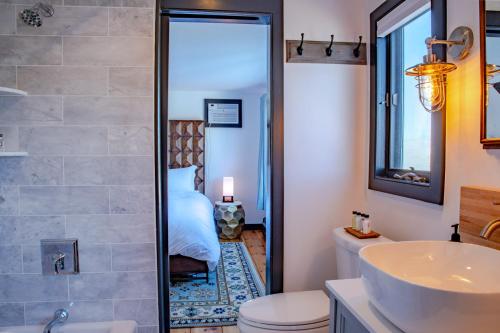 a bathroom with a shower and a toilet and a sink at Addison Choate in Rockport