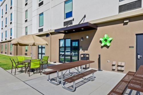 a patio with a table and chairs and a building at Extended Stay America Premier Suites - Savannah - Pooler in Savannah