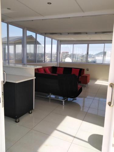 a view of a room with chairs and windows at Sancta Maria 10 - Ultimate in luxury & majestic sea views includes private entertainment deck - Free wifi in Kingsburgh