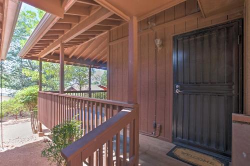 a front porch of a house with a black door at Near Golfing and Hiking Payson Family Cabin! in Payson