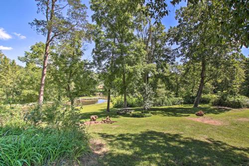 a park with trees and a picnic table in the grass at Turtle Rock - Ironton Cabin with Furnished Patio! in Ironton