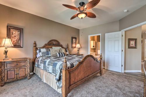 a bedroom with a bed and a ceiling fan at Lakefront Balcony and Pool Access Camdenton Condo in Camdenton